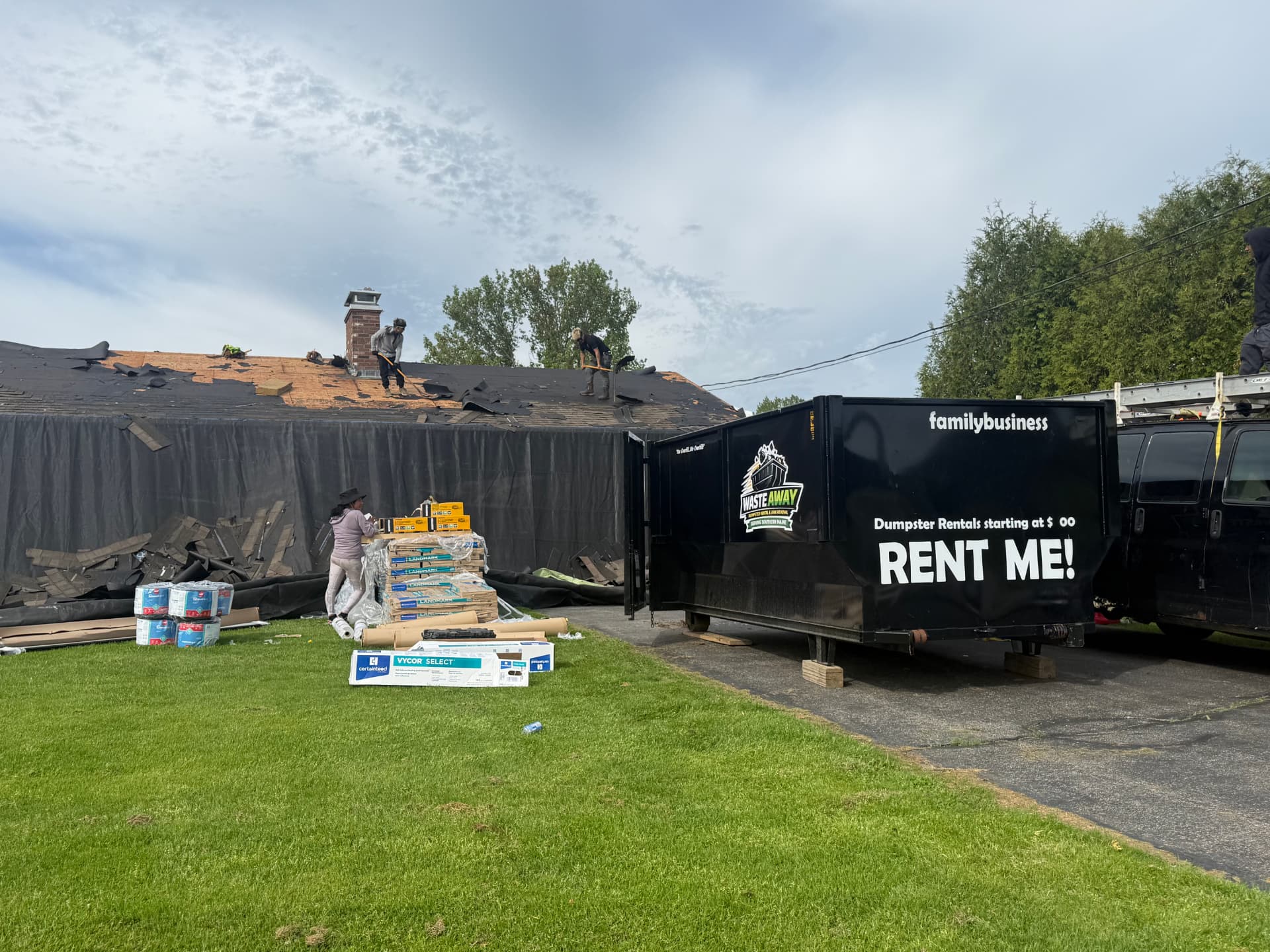 Waste Away dumpster on a roofing tear-off job site